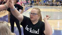 Image of girl giving high five with a shirt that says be kind