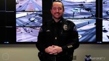 Aurora police officer standing inside real time information center