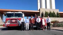 City members outside the Aurora Highlands with a fire engine