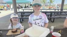 Two little girls smiling with gluten free donuts