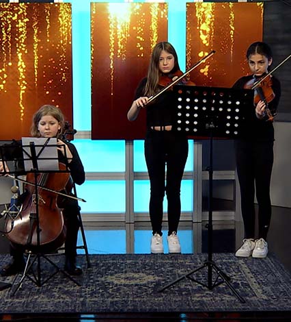 A trio plays music in the AuroraTV studio