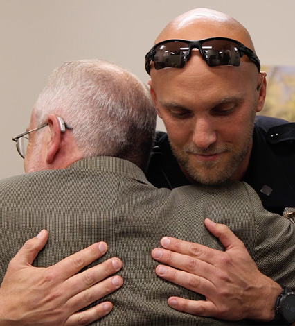 APD officer hugs man he helped save