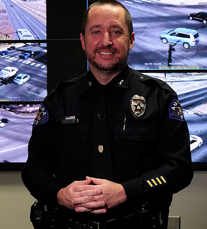 Aurora police officer standing inside real time information center