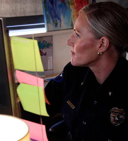 APD officer looking at computer screen