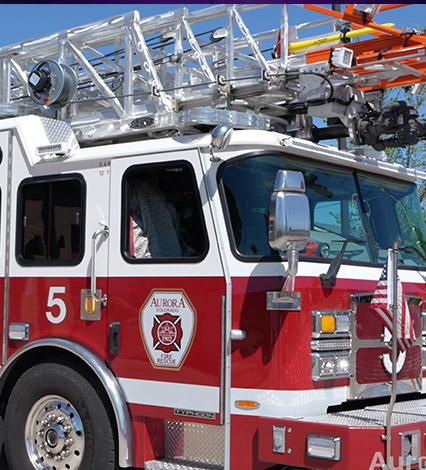 Big, red Aurora Fire Rescue fire truck with ladder on top