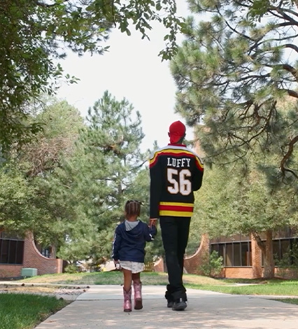  SAVE program participant holding hand and walking with young daughter