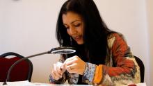 Photo of I Love ME Gems founder Yurima Crowley working on jewelry