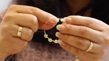 woman working on earring