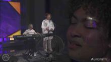 woman singing and child playing piano