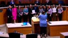 Group of people in the Aurora City Council Chamber