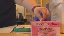 hand grabbing rubber glove from box in medical office