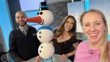 Anchors smiling with snowman