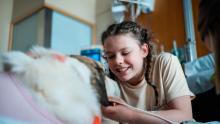 Children's Colorado patient smiling at dog