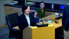 Woman speaker at the podium in the Aurora Room at the Aurora Municipal Center that links to the June 10 2024 Council Study Session