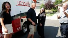 People smiling in front of UCHealth Mobile Stroke Unit