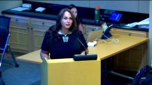 Woman standing at the podium in the Aurora Room at the Aurora Municipal Center that links to the July 8 2024 City Council Study Session