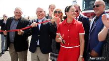 City and community officials cutting a ribbon to celebrate new interchange