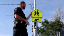 officer points to crosswalk