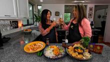 Lindita and her sister in the kitchen with all the food they made