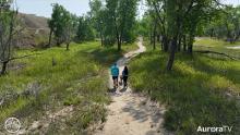 couple walking Aurora Animal Shelter dog on walk 