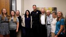 Group photo with APD officer and man he saved