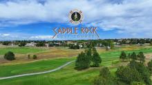 Aerial of Saddle Rock golf course with logo in sky