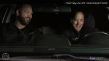 Aurora Police Department members in car reenacting Home Alone scene