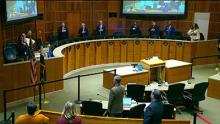 City council members in chambers doing the pledge