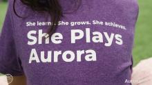 Back of t-shirt that reads "She Plays Aurora"