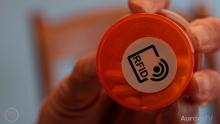 close up of an RFID label on the bottom of an orange prescription pill bottle