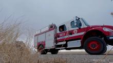 Aurora Fire Rescue wildland fire truck and dried out vegetation in foreground