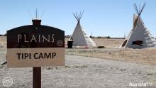 Plains Tipi Camp sign with two actual tipis in the background