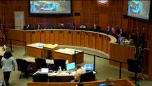 The Aurora City Council in chambers during a meeting.