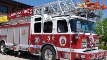 Big, red Aurora Fire Rescue fire truck with ladder on top