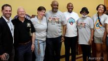 group of city, state and NAACP leaders smiling and posing for photo at Juneteenth event