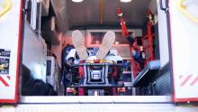 man's feet on stretcher inside Falck ambulance