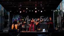 Mayra Alejandra singing with her band on stage