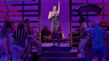 woman singing on stage performing in the play, "Violet"