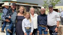 members of the Windler family standing together and smiling, some wearing cowboy hats