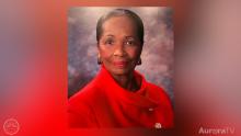 Edna wearing a bright red dress and smiling at the camera