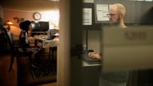 bling Aurora resident using assistive technology to read screen and city employee working on computer to make city website digitally accessible