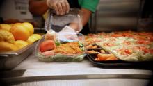 Overland High School lunch with chicken and tomato next to fruit and veggies