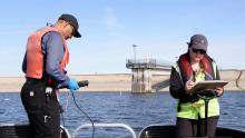 Aurora Water employees on boat collecting water samples on Aurora Reservoir